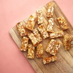 Wooden cutting board displaying tasty homemade nut bars, ready to eat.